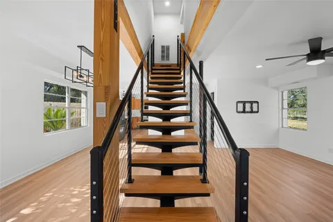 a view of a livingroom with a ceiling fan and window