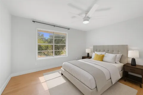 a large white room with a large window and couch