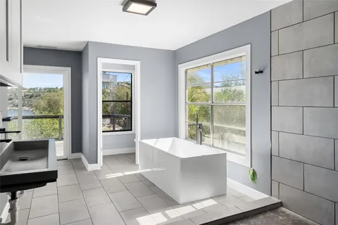 a large white room with a large window and couch