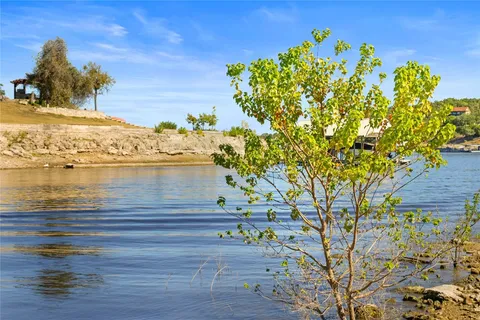 a view of a lake with houses in the back