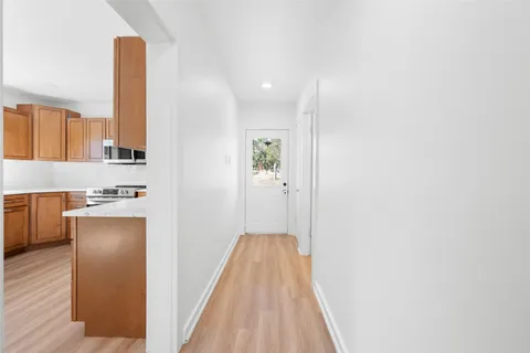a view of a kitchen with a refrigerator and a sink