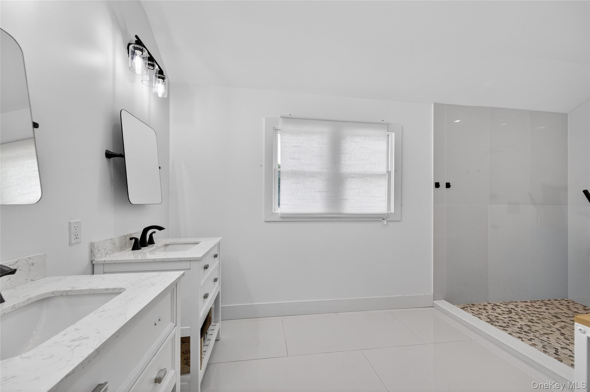 534 Riverside Avenue Massapequa, NY 11758 - Photo 17 of 28 a bathroom with a sink and a mirror