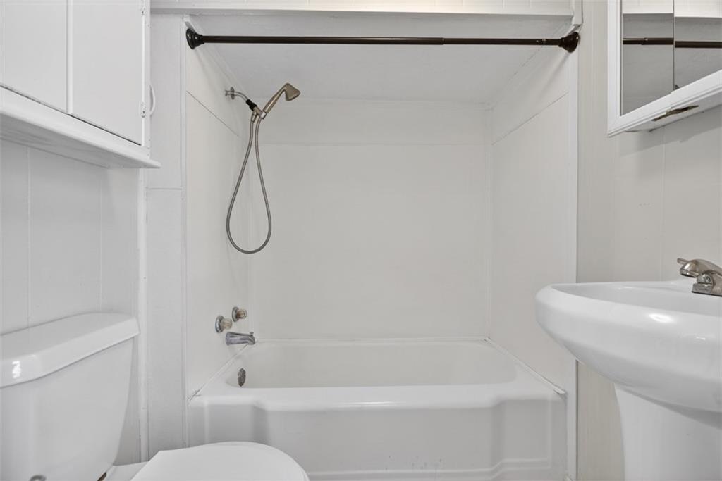 246 Spring Street Commerce, GA 30529 - Photo 14 of 23 a bathroom with a bath tub with a shower