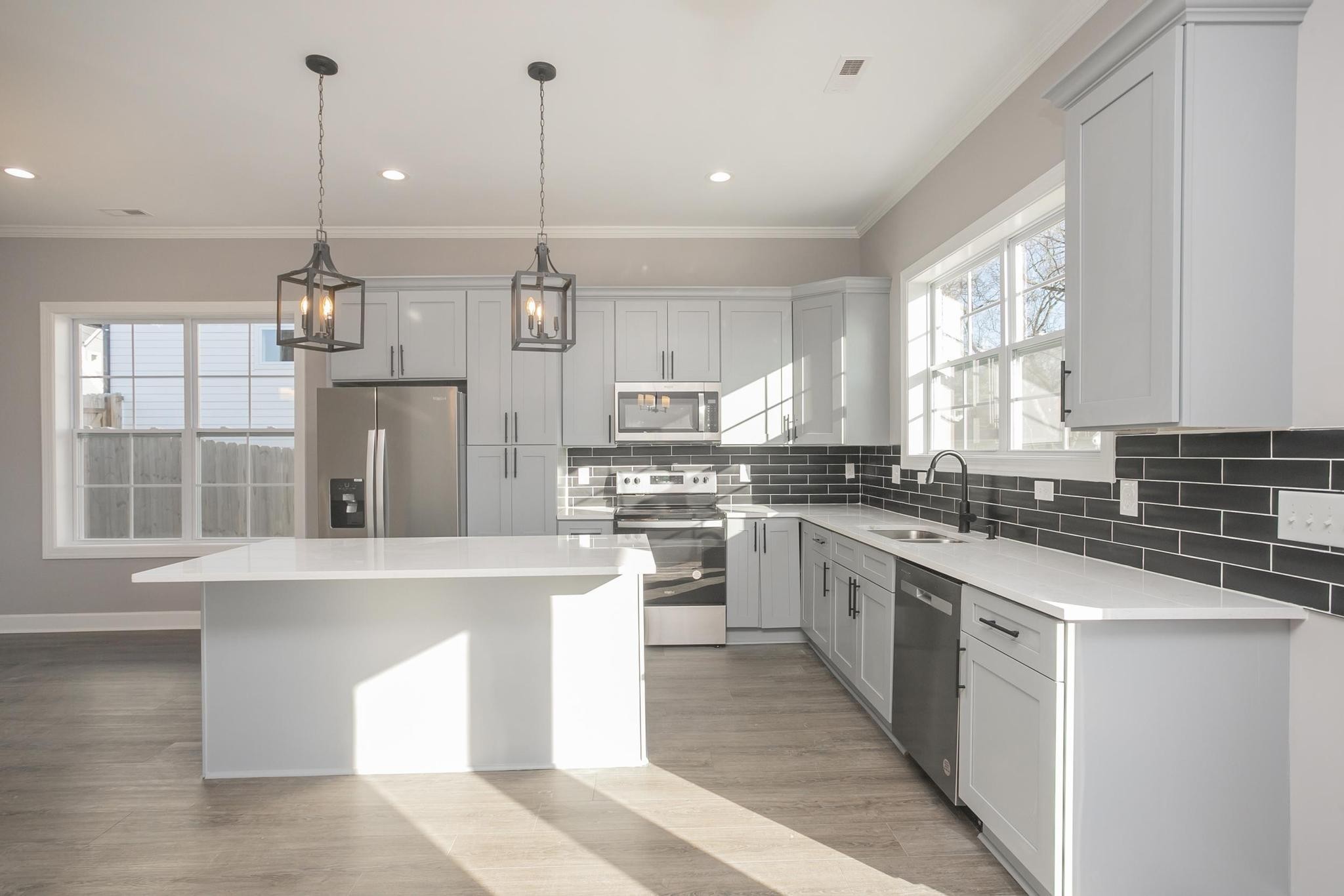 4329 Old Goins Road Nashville, TN 37211 - Photo 3 of 24 a kitchen with kitchen island a stove a sink a center island and windows