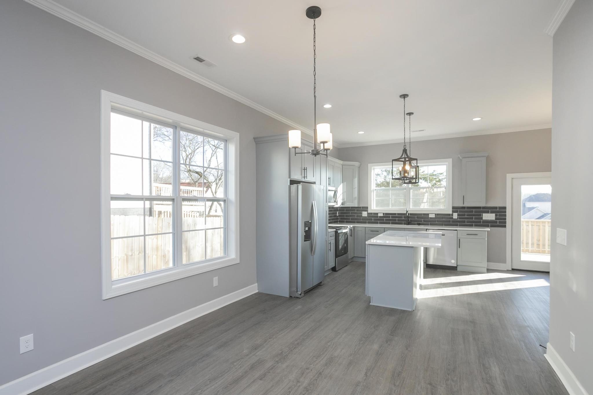 4329 Old Goins Road Nashville, TN 37211 - Photo 9 of 24 a open kitchen with stainless steel appliances granite countertop a refrigerator a sink dishwasher a stove and white countertops with wooden floor