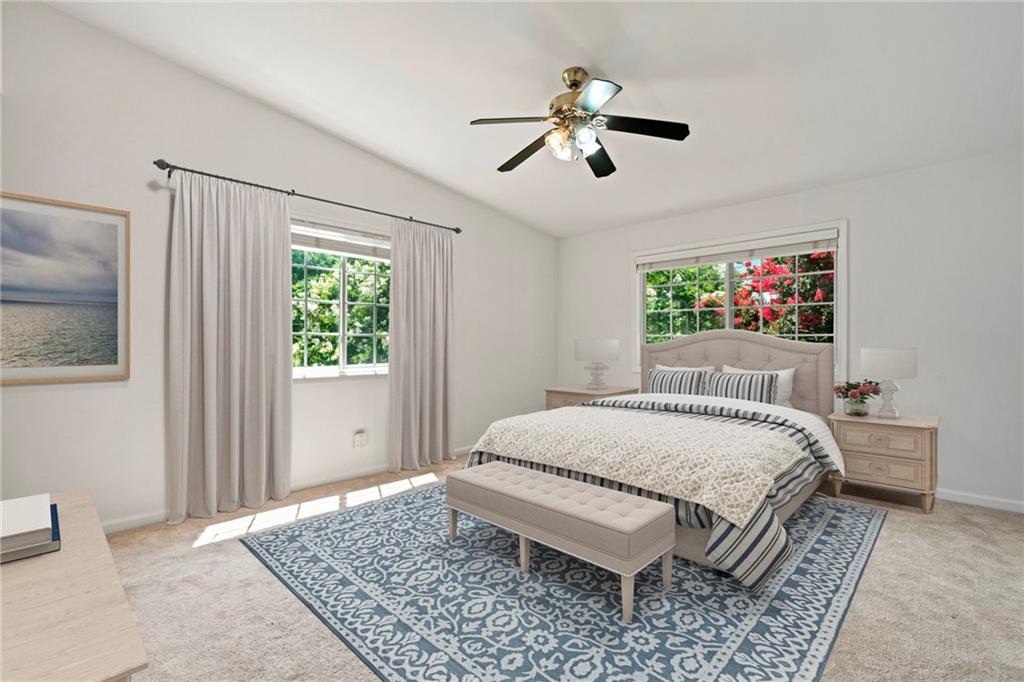 1468 Briarwood Road Northeast, Unit 108 Atlanta, GA 30319 - Photo 12 of 33 a bedroom with a large bed and a chandelier