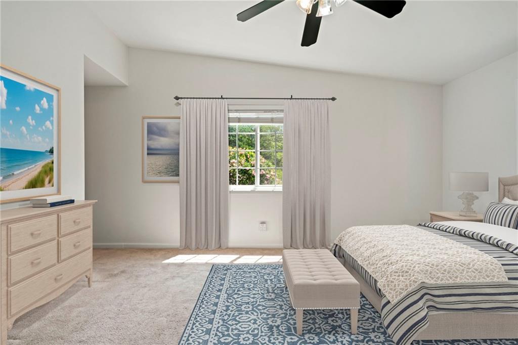 1468 Briarwood Road Northeast, Unit 108 Atlanta, GA 30319 - Photo 14 of 33 a bedroom with a large bed and a chandelier fan