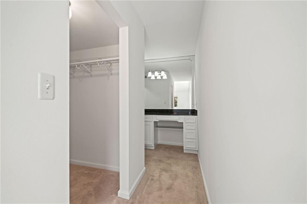 1468 Briarwood Road Northeast, Unit 108 Atlanta, GA 30319 - Photo 15 of 33 a view of a hallway and a livingroom with a chair