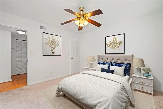 a bedroom with a bed and a painting on the wall