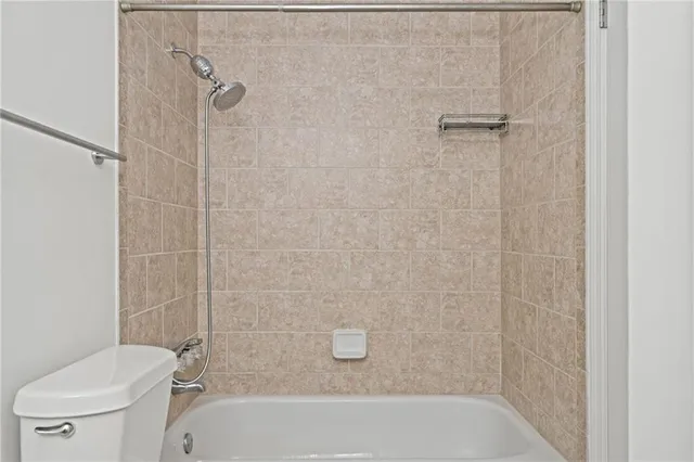 a bathroom with a bathtub and a toilet