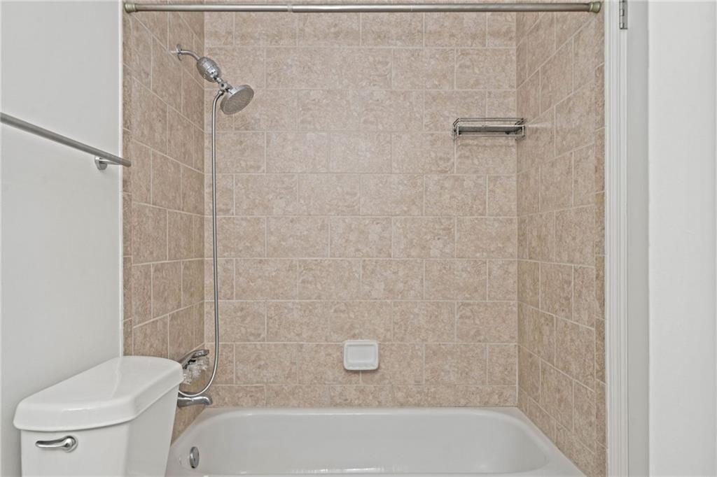 1468 Briarwood Road Northeast, Unit 108 Atlanta, GA 30319 - Photo 23 of 33 a bathroom with a bathtub and a toilet