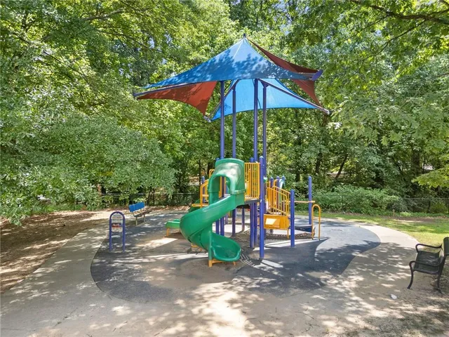a view of outdoor space with playground and green space