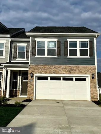 a front view of a building with a garden