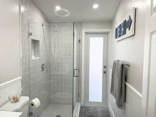 a bathroom with a shower and a sink