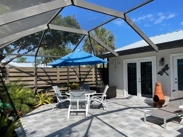 a view of a chair and tables in the patio