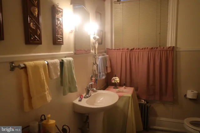 a bathroom with sink a mirror a vanity and shower
