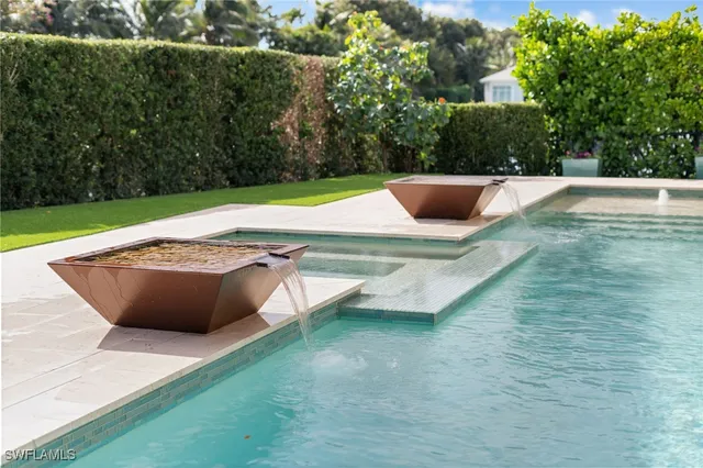 a view of a swimming pool with a yard