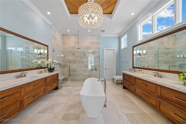 a bathroom with a granite countertop sink a toilet a mirror and bathtub
