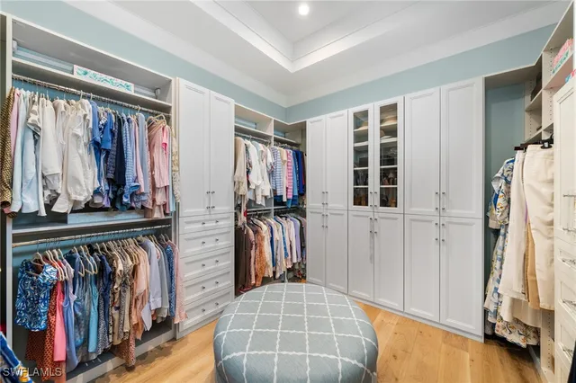 a view of walk in closet with clothes and shoes