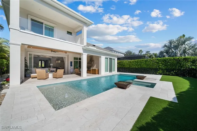 a front view of a house with a garden and plants