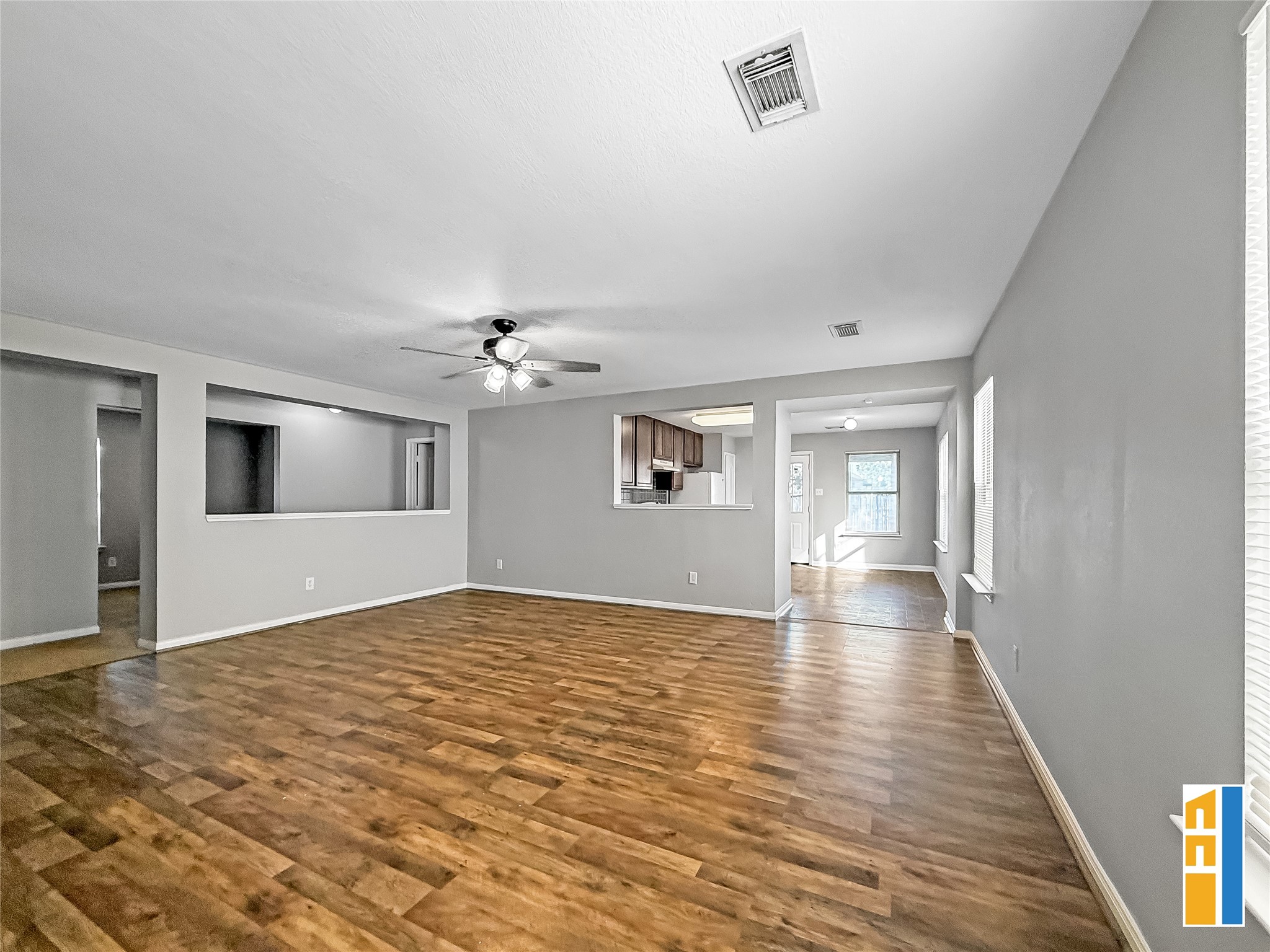29566 North Legends Bend Drive Spring, TX 77386 - Photo 9 of 21 This inviting living area boasts a spacious open layout with warm wood flooring, abundant natural light, and seamless flow to the adjacent kitchen and dining spaces, perfect for both relaxation and entertaining.