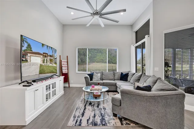 a living room with furniture and a floor to ceiling window
