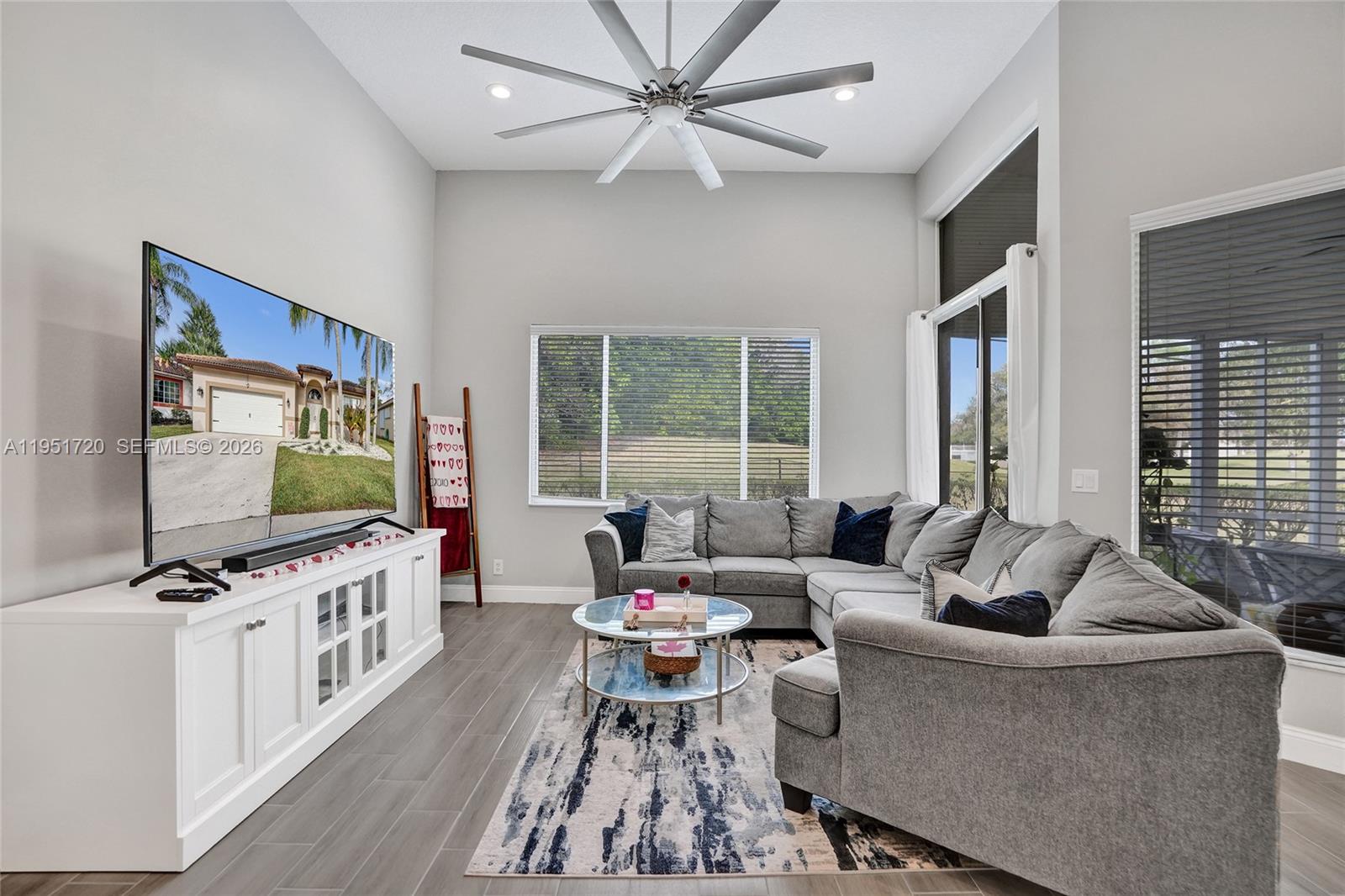 8795 Northwest 76th Place Tamarac, FL 33321 - Photo 14 of 69 a living room with furniture and a flat screen tv
