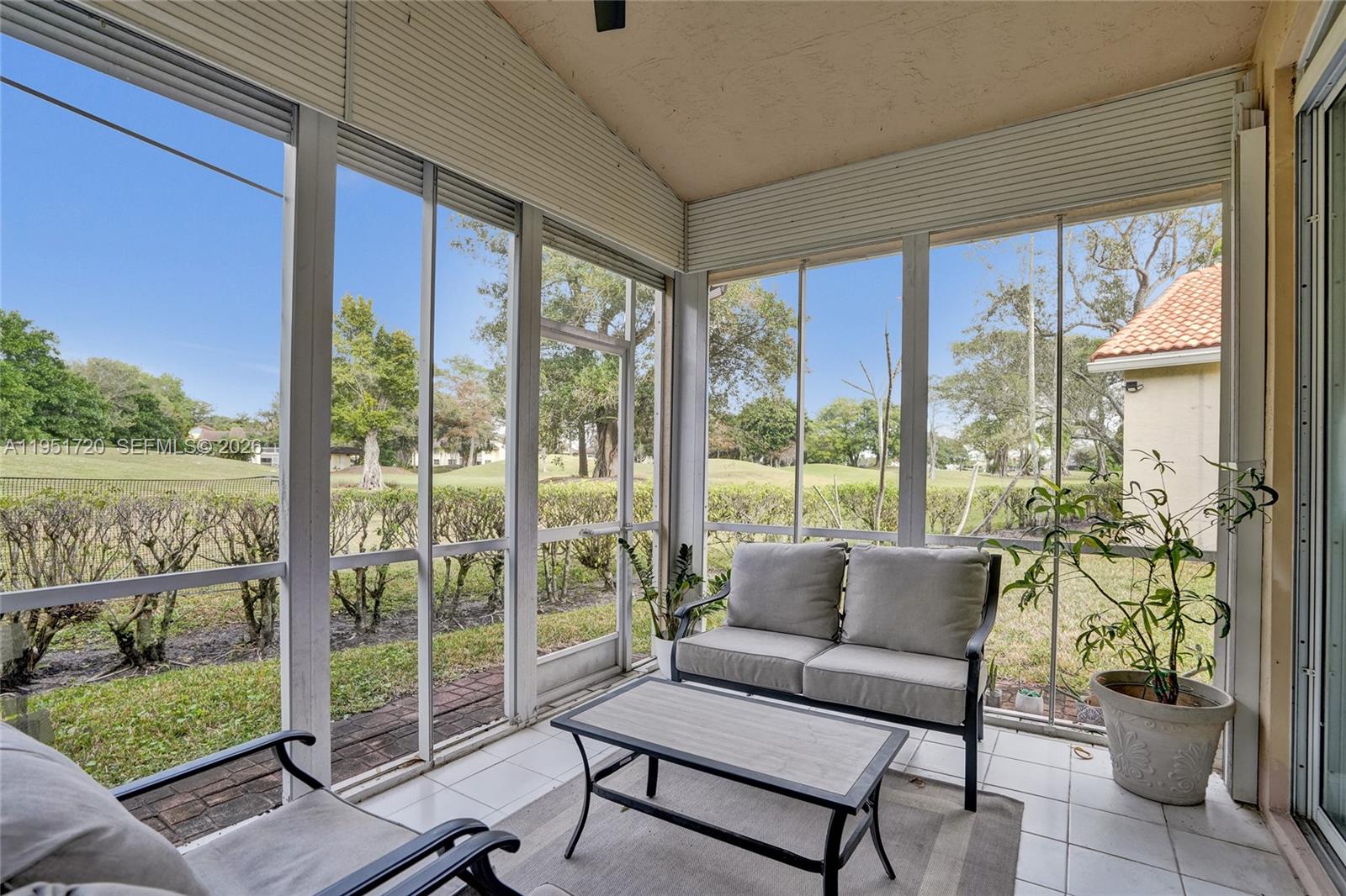 8795 Northwest 76th Place Tamarac, FL 33321 - Photo 2 of 69 a living room with furniture and a floor to ceiling window