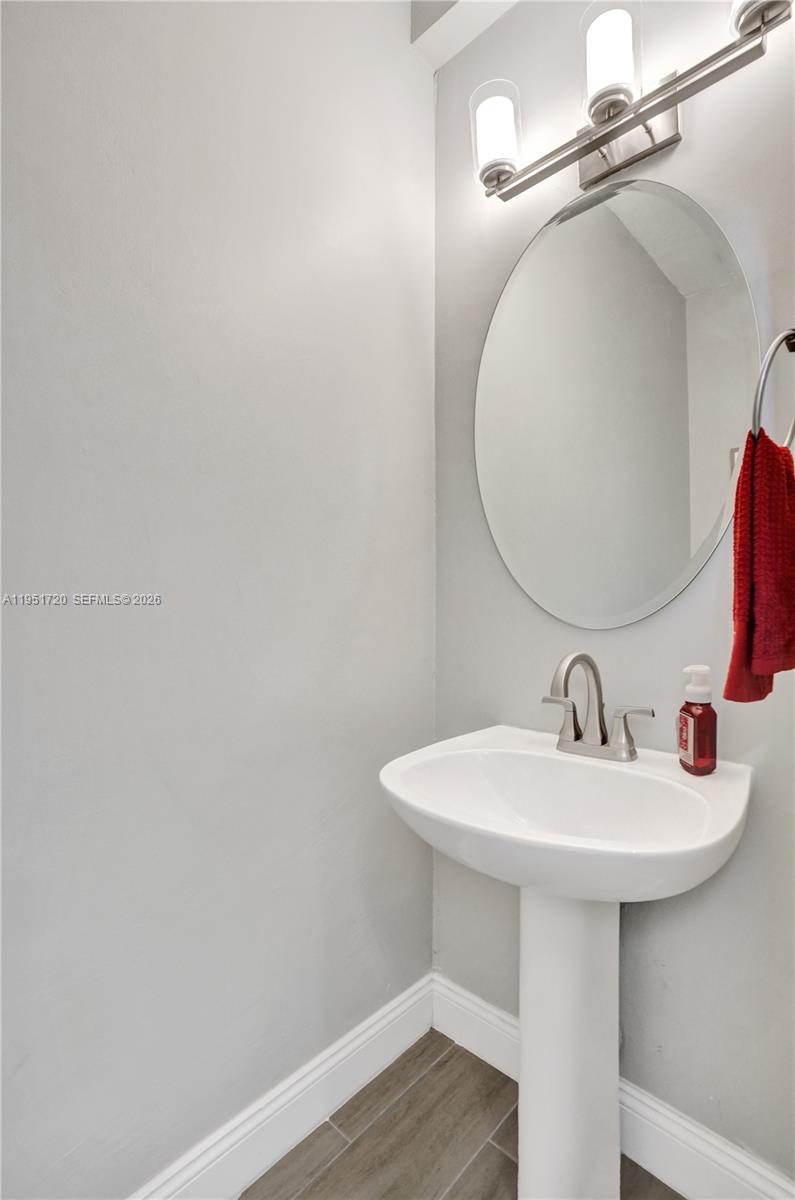 8795 Northwest 76th Place Tamarac, FL 33321 - Photo 29 of 69 a bathroom with a sink a mirror and vanity