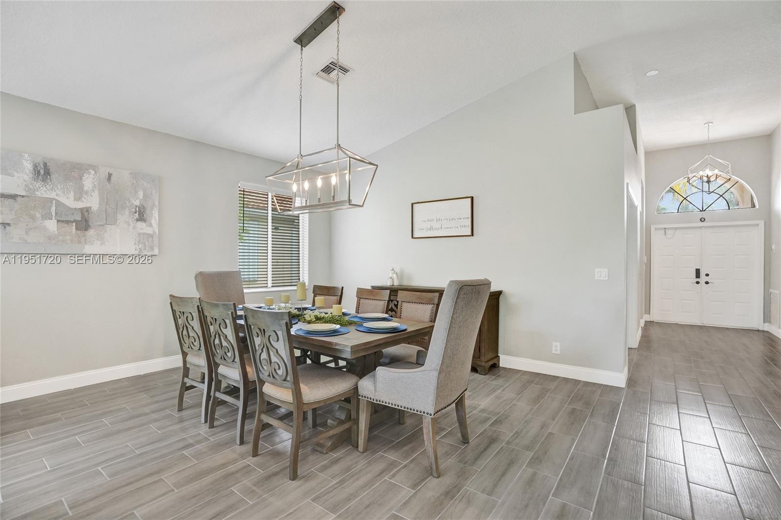 8795 Northwest 76th Place Tamarac, FL 33321 - Photo 37 of 69 a view of a dining room with furniture window and wooden floor