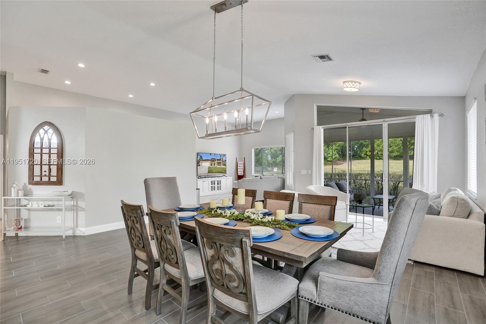 8795 Northwest 76th Place Tamarac, FL 33321 - Photo 39 of 69 a view of a dining room with furniture window and wooden floor