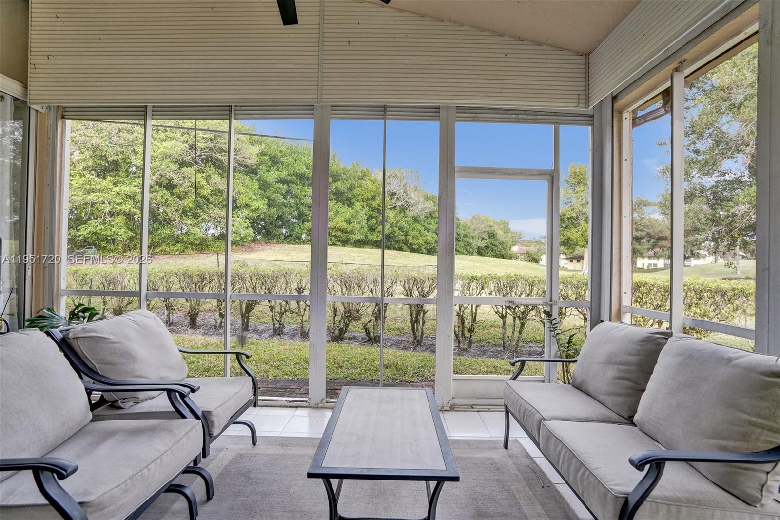 8795 Northwest 76th Place Tamarac, FL 33321 - Photo 61 of 69 a living room with furniture and a floor to ceiling window
