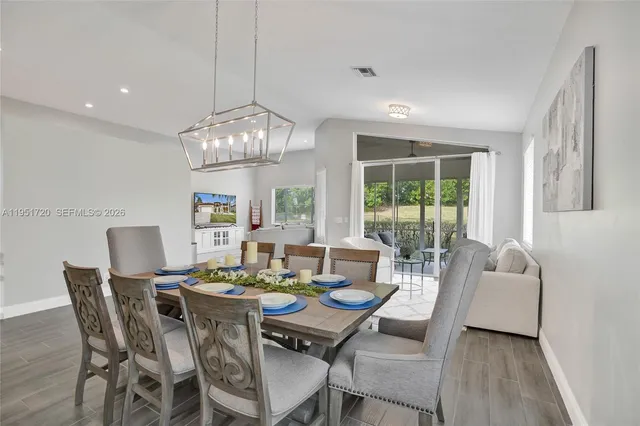 a bedroom with a bed and a flat tv screen on dresser