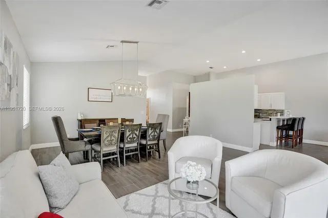 a bathroom with a bathtub a sink a mirror and a window