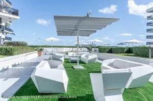a dining room with furniture a chandelier and wooden floor