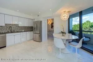 a large white kitchen with a large window