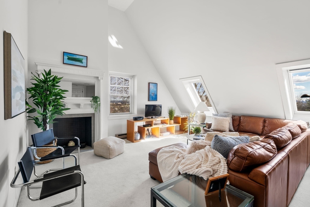 a living room with furniture fireplace and a fireplace