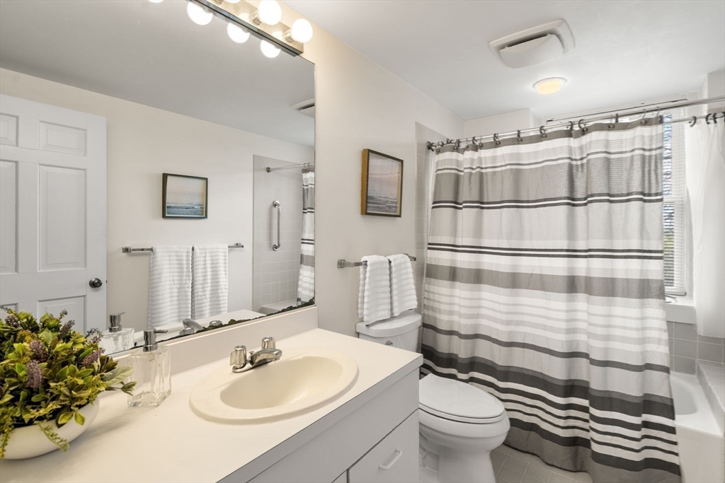 456 Belmont Street, Unit 21 Watertown, MA 02472 - Photo 11 of 19 a bathroom with a sink toilet and shower