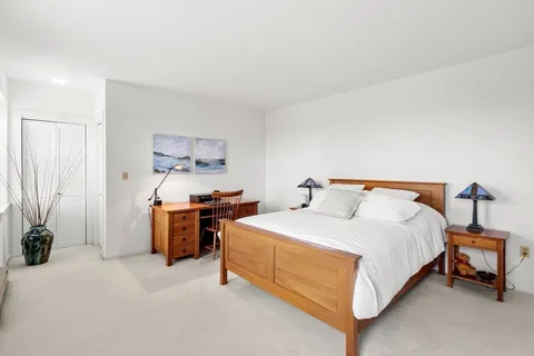 a bedroom with bed and a chandelier