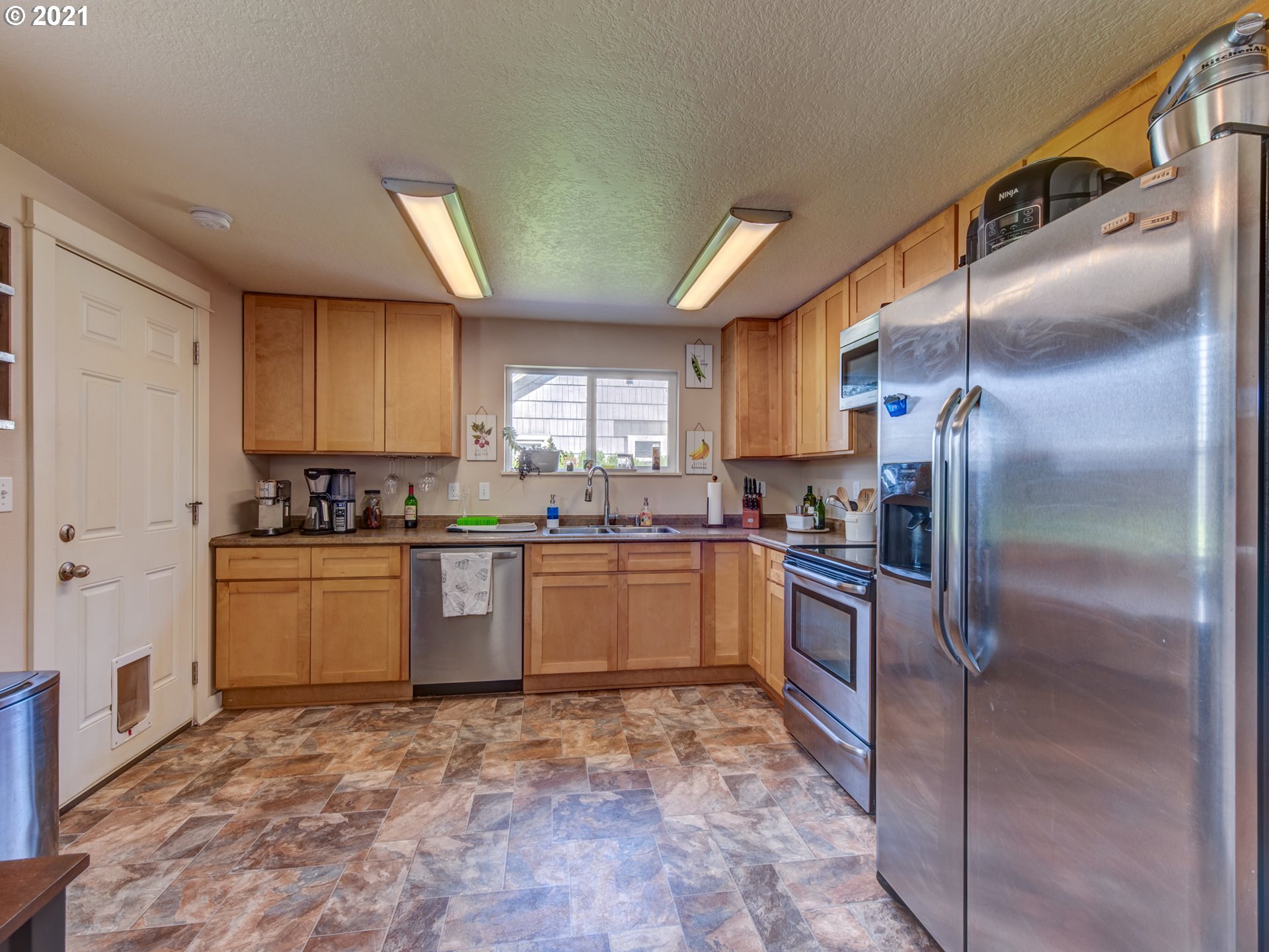 468 17th Street Springfield, OR 97477 - Photo 7 of 21 a kitchen with a refrigerator sink and cabinets