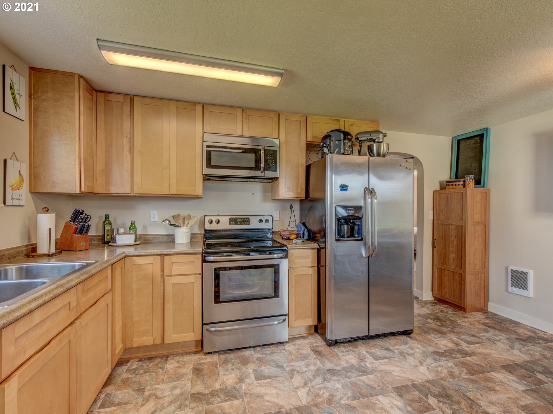 468 17th Street Springfield, OR 97477 - Photo 8 of 21 a kitchen with stainless steel appliances granite countertop a refrigerator a stove and a sink