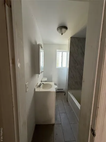 a bathroom with a sink toilet and tub