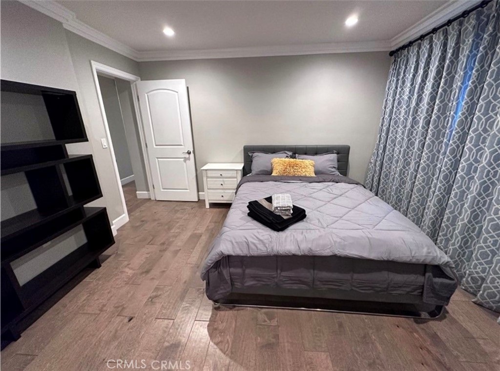 412 Magellan Road Arcadia, CA 91007 - Photo 14 of 15 a bedroom with a bed a mirror and wooden floor