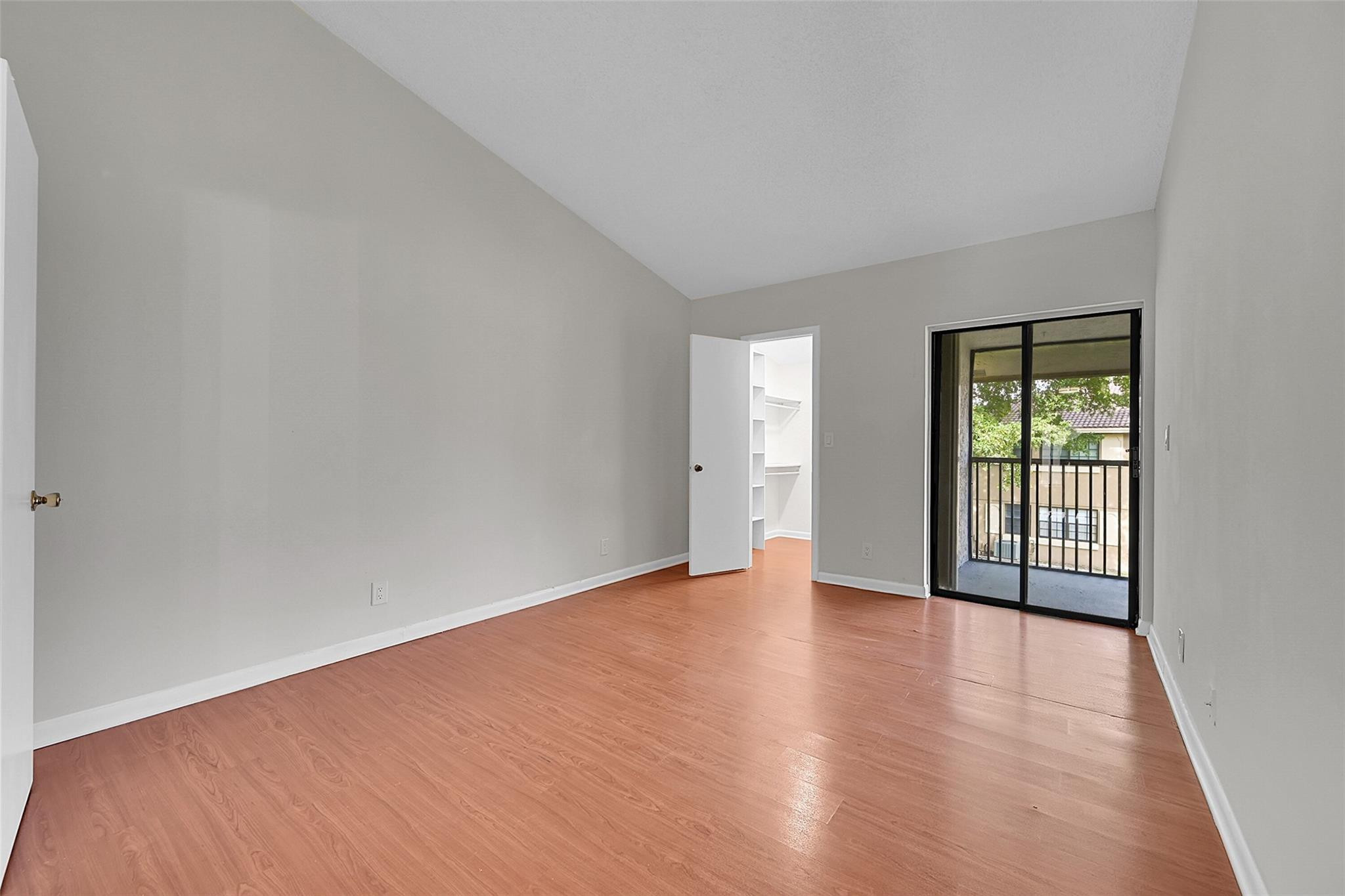 2578 Riverside Drive, Unit 421 Coral Springs, FL 33065 - Photo 12 of 29 a view of an empty room with wooden floor and a window
