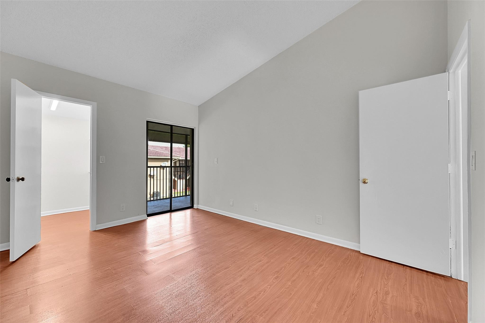 2578 Riverside Drive, Unit 421 Coral Springs, FL 33065 - Photo 13 of 29 a view of an empty room with wooden floor and a window