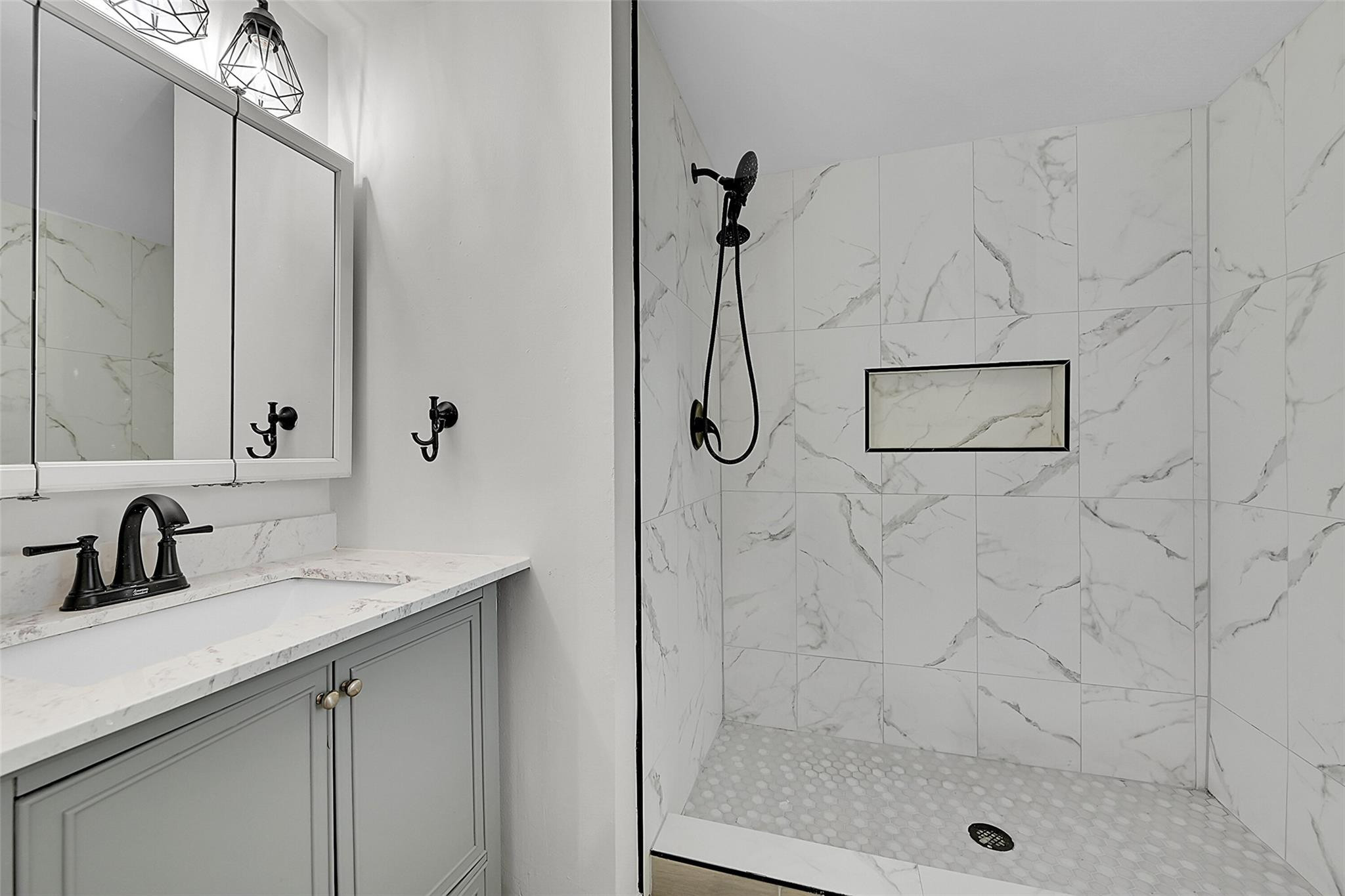 2578 Riverside Drive, Unit 421 Coral Springs, FL 33065 - Photo 17 of 29 a bathroom with a sink mirror and shower