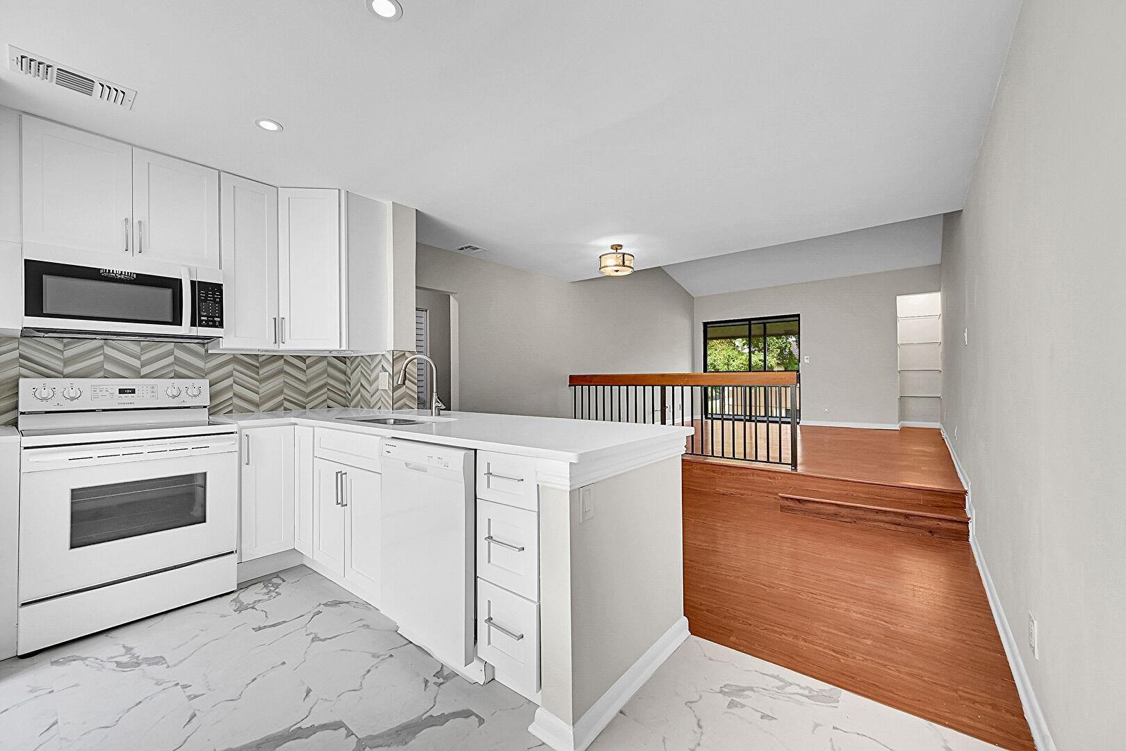 2578 Riverside Drive, Unit 421 Coral Springs, FL 33065 - Photo 2 of 29 a kitchen with stainless steel appliances a stove a sink and a microwave