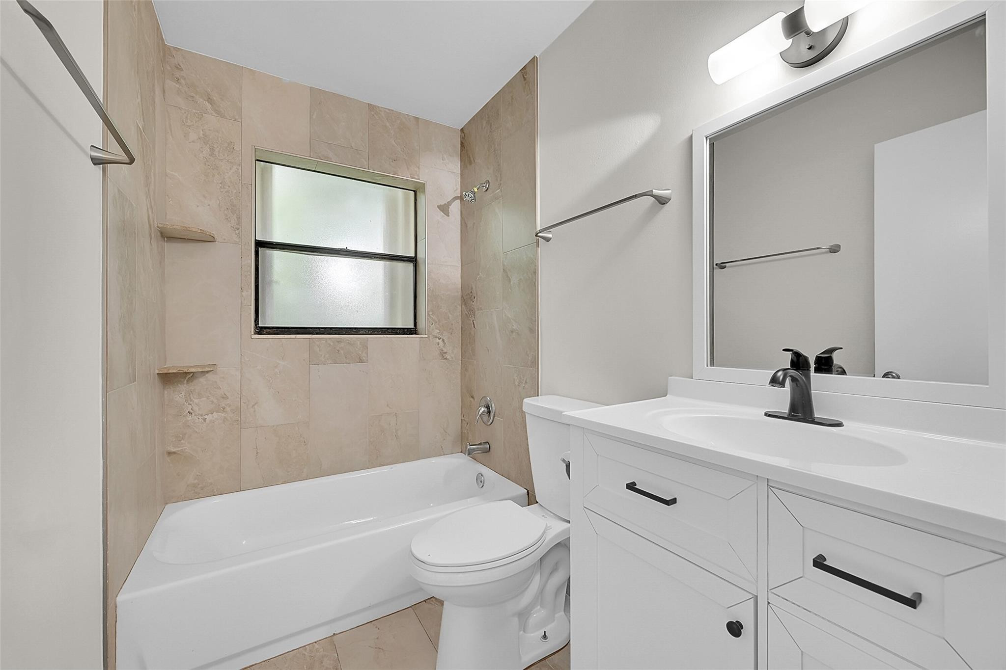 2578 Riverside Drive, Unit 421 Coral Springs, FL 33065 - Photo 21 of 29 a bathroom with a sink a toilet and shower