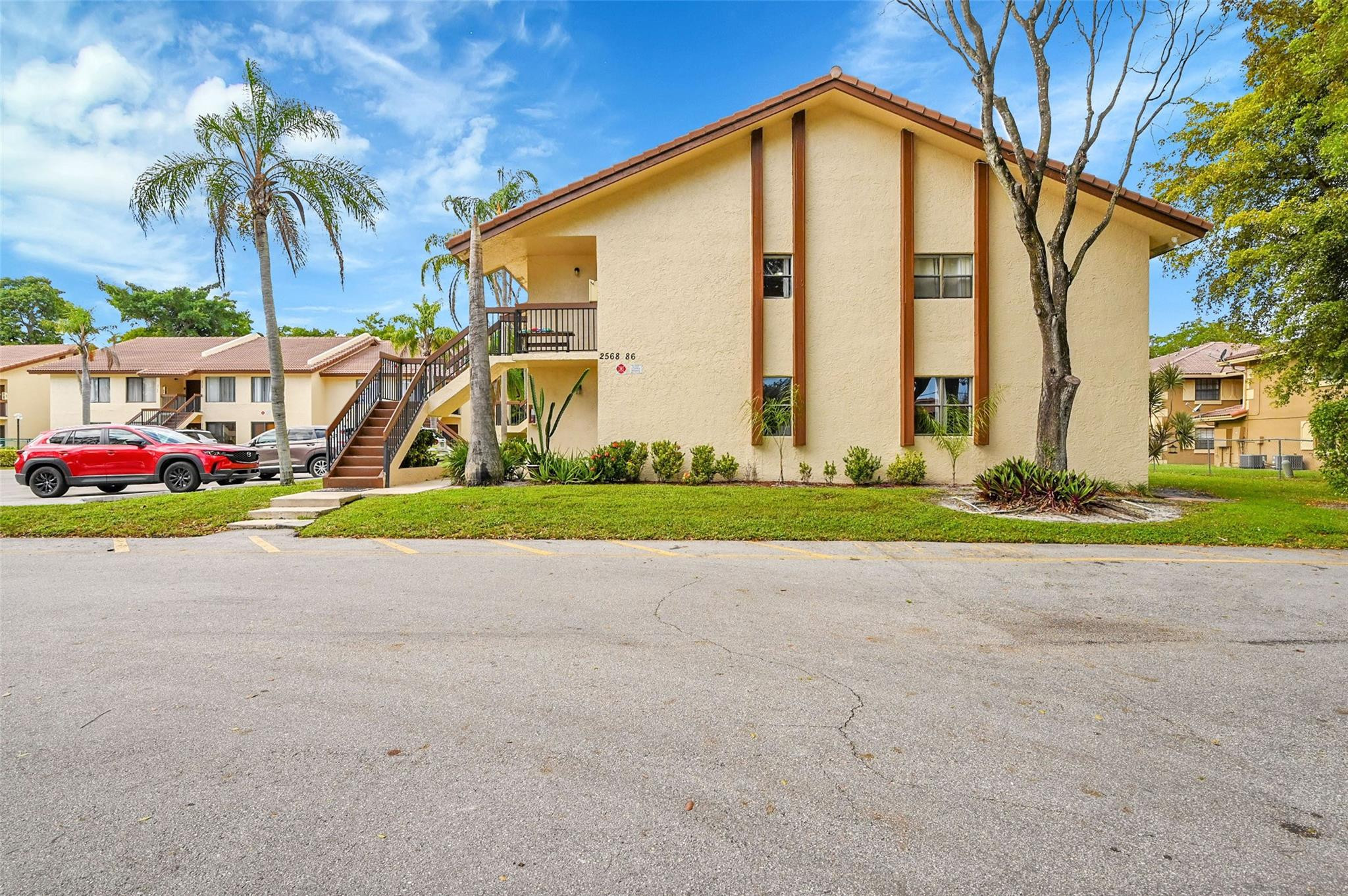 2578 Riverside Drive, Unit 421 Coral Springs, FL 33065 - Photo 28 of 29 a view of backyard of yellow house