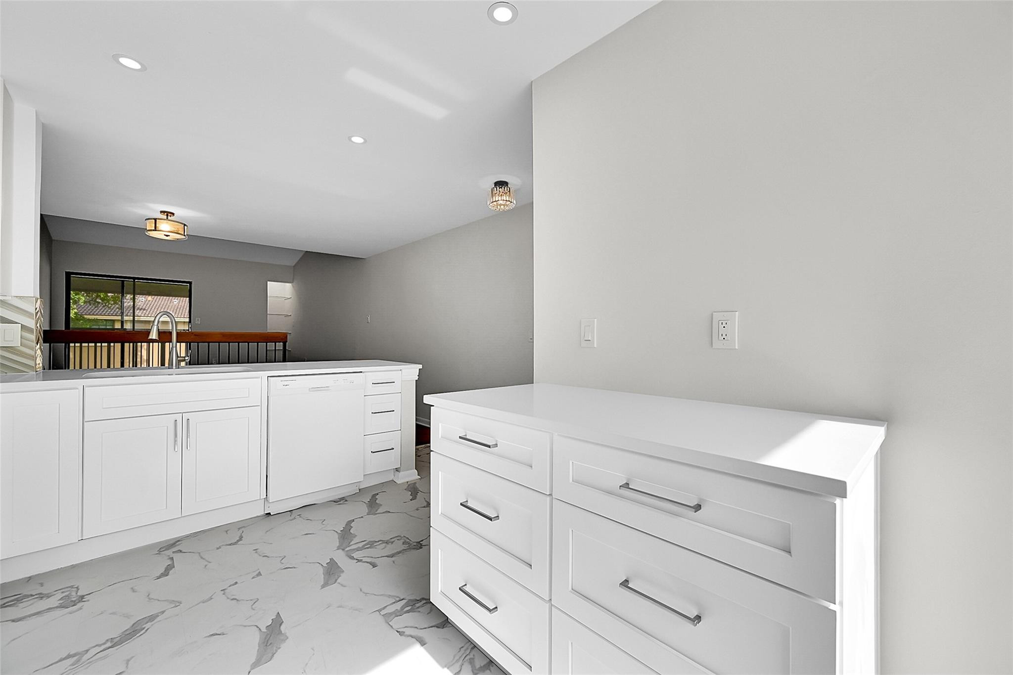 2578 Riverside Drive, Unit 421 Coral Springs, FL 33065 - Photo 4 of 29 a kitchen with white cabinets and white appliances